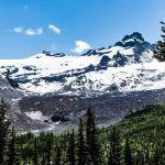 Ice Caves - a snow covered mountain surrounded by pine trees