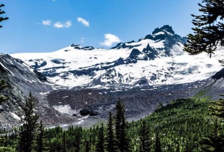 Ice Caves - a snow covered mountain surrounded by pine trees