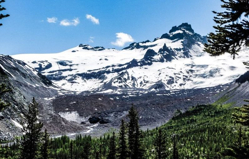 Ice Caves - a snow covered mountain surrounded by pine trees