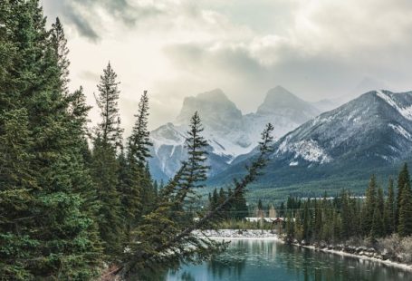 Banff Park - green pine trees near lake and snow covered mountain during daytime