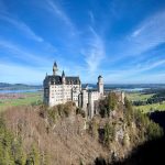 Romantic Road - a castle on top of a hill surrounded by trees
