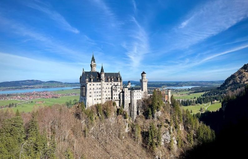Romantic Road - a castle on top of a hill surrounded by trees