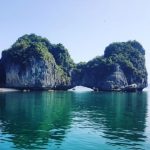 Halong Bay - white boat on sea near green mountain during daytime