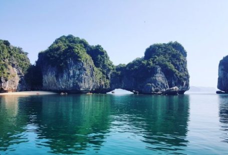 Halong Bay - white boat on sea near green mountain during daytime