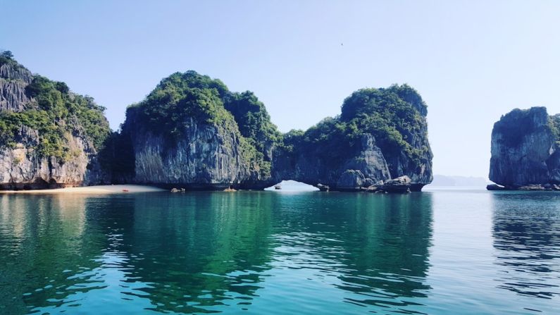 Halong Bay - white boat on sea near green mountain during daytime