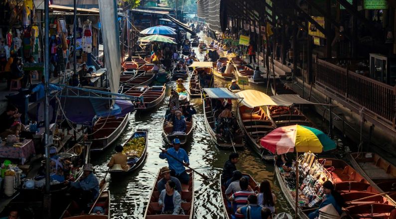 Floating Market - people riding on boat on river during daytime