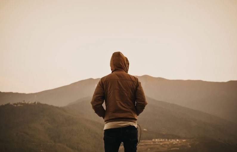 Bhutan Mountains - person wearing brown hoodie