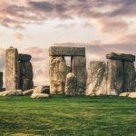 Stonehenge - gray rock formation on green grass field under gray cloudy sky