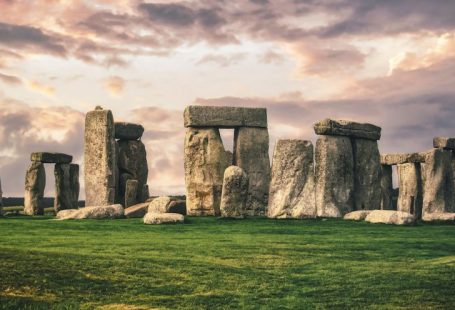 Stonehenge - gray rock formation on green grass field under gray cloudy sky