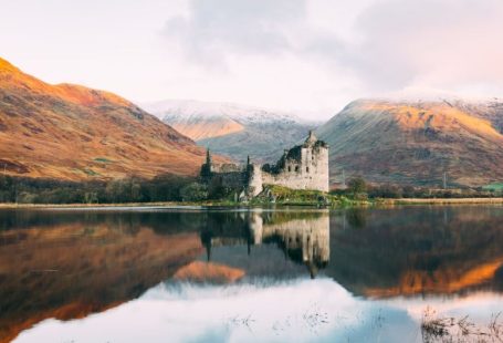 Scottish Highlands - gray concrete building near lake under white sky during daytime