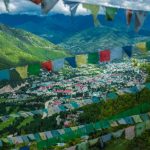 Bhutan Temple - green mountain under white clouds during daytime