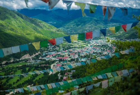 Bhutan Temple - green mountain under white clouds during daytime