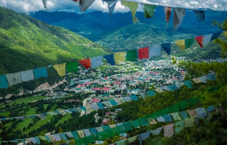Bhutan Temple - green mountain under white clouds during daytime