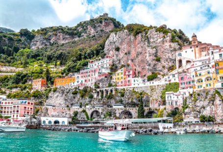Amalfi Coast - white boat on body of water near green and brown mountain during daytime