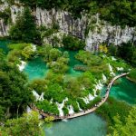 Plitvice Lakes - aerial view of river between rocky mountains during daytime