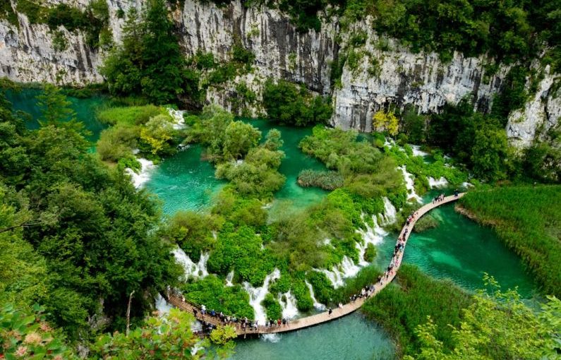 Plitvice Lakes - aerial view of river between rocky mountains during daytime