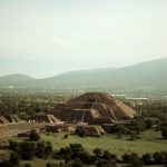 Teotihuacan - brown house on green grass field near green mountains during daytime