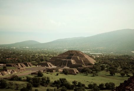 Teotihuacan - brown house on green grass field near green mountains during daytime