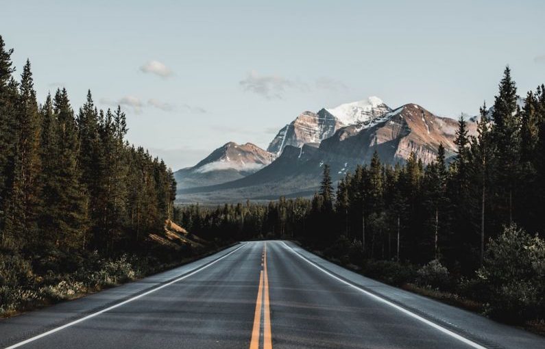 Canadian Rockies - wide road under blue sky