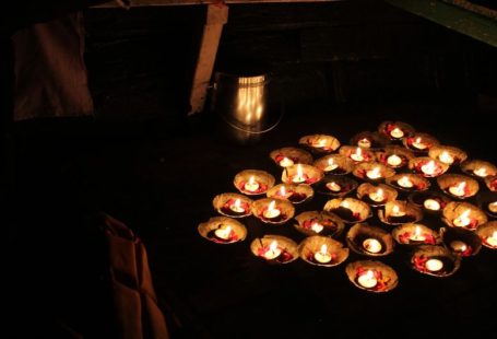 Varanasi Ganges - a bunch of lit candles sitting on top of a table